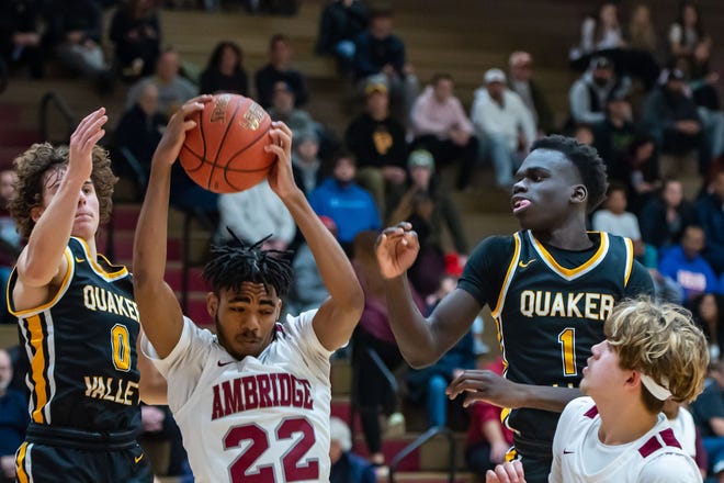 Quaker Valley's Troy Kozar, left, and Dana Kromah surround Ambridge's Karmelo Green Monday at Ambridge Area High School. [Lucy Schaly/For BCT]