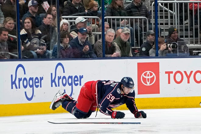 Dec 19, 2022; Columbus, Ohio, USA; Columbus Blue Jackets right wing Yegor Chinakhov (59) gets up slowly after a Dallas Stars player fell on his knee during the first period of their NHL game at Nationwide Arena. Chinakhov left the game and didn't return.