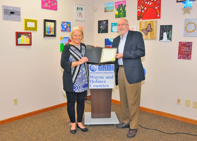 Helen Walkerly, a tireless advocate for mental health programs, poses with Wayne County Commissioner Ron Amstutz recently during her retirement celebration recently a NAMI.