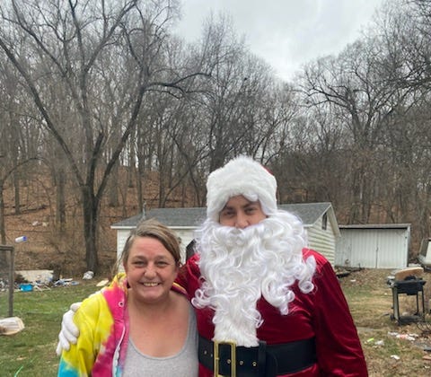 Bobbie Berryman stands for a photo with Santa on Dec. 17, 2022. The Peoria County Sheriff's Office dropped off gift cards and presents as part of the Paul Reatherford and Jerry Brady Christmas Basket Program.