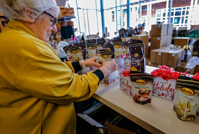Workers make holiday packages of goods Dec. 19 inside the Chickasaw Nation's Bedré Fine Chocolate in Davis.