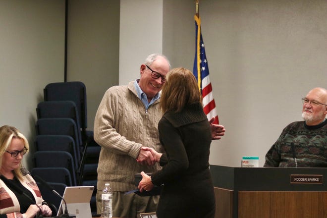 Commissioner James Weese shakes hands with Nancy Bassett, a Saline County employee since 1977, who is retiring this year.