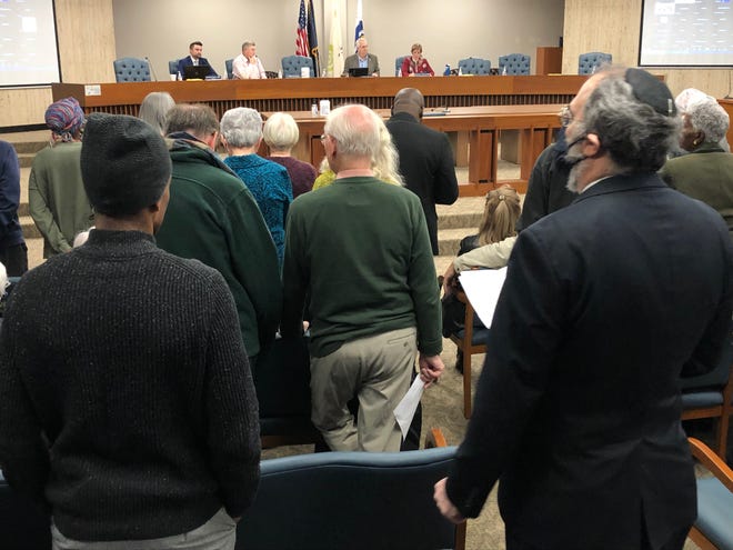 Members of Faith in Indiana, who advocate for the Behavioral Crisis Center, stand in protest during a St. Joseph County commissioners meeting on December 20, 2022.