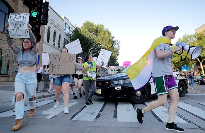 A crowd marches on College Avenue during a protest of the U.S. Supreme Court's overturning Roe v. Wade, on Friday, June 24, 2022, in Appleton, Wis.