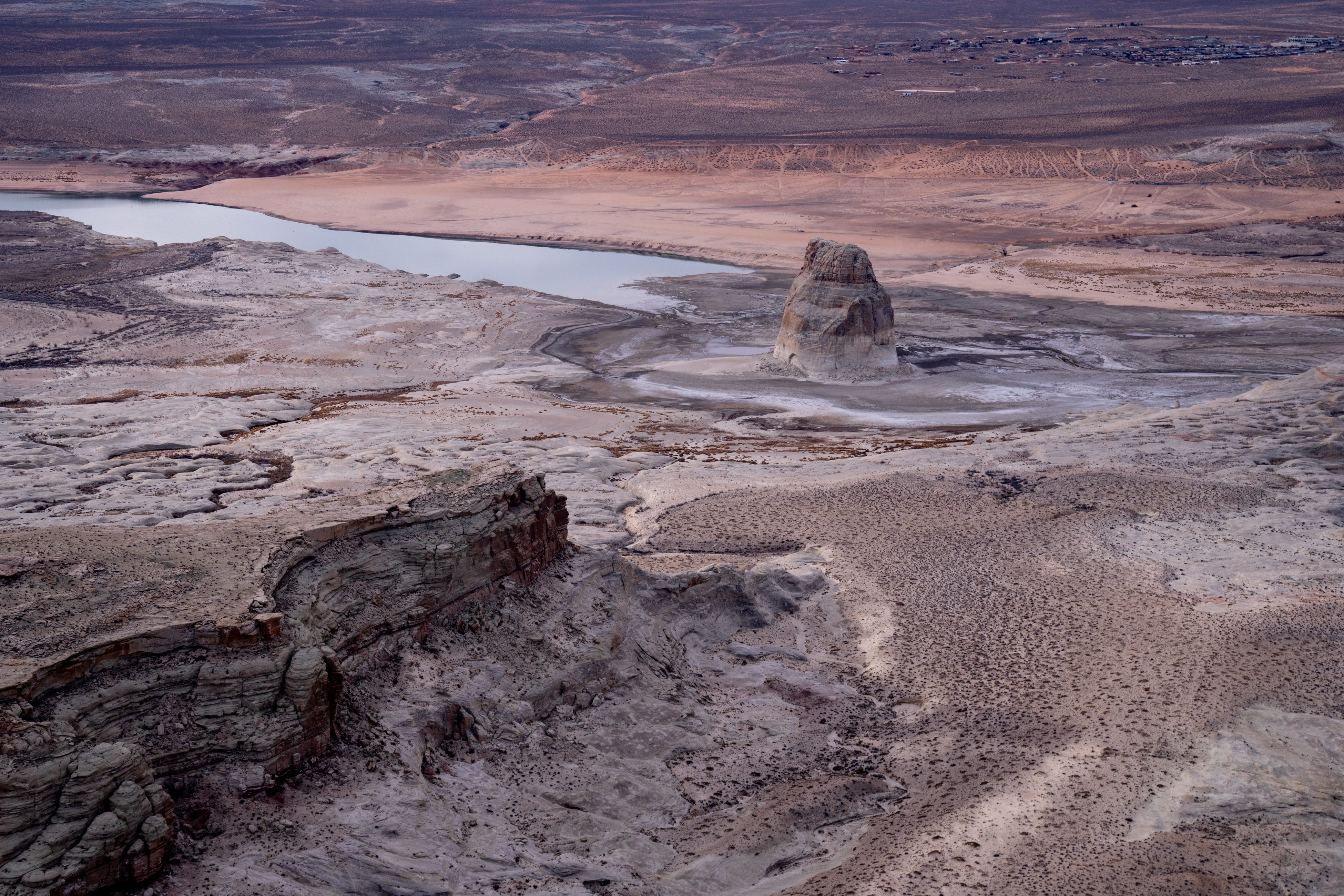 Lone Rock in Lake Powell’s Wahweap Bay on the Arizona-Utah border as seen on Feb. 1, 2022. When full, the bay surrounded this feature. Water levels in this Colorado River reservoir have dropped significantly, affecting recreation and nearby residents.