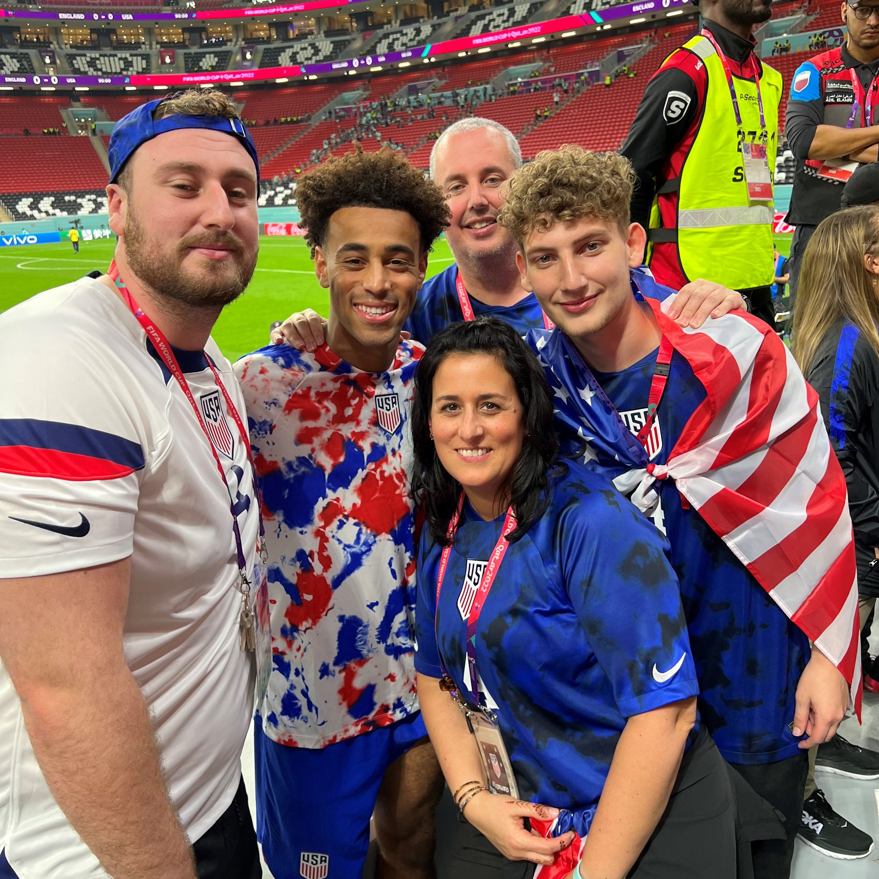 Tyler Adams poses with his family in the stands at Al Bayt Stadium in Qatar after helping the United States play to a scoreless tie against England in the World Cup on Nov. 25, 2022. From left: Darryl Sullivan Jr., Tyler Adams, Darryl Sullivan Sr., Melissa Russo and Donovan Sullivan.