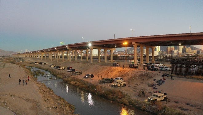 Texas National Guard troops and equipment are deployed along the north bank of the Rio Grande on Dec. 20, 2022. Personnel using bull horns are advising migrants that crossing at that location is illegal and that they should attempt to cross at a port of entry.