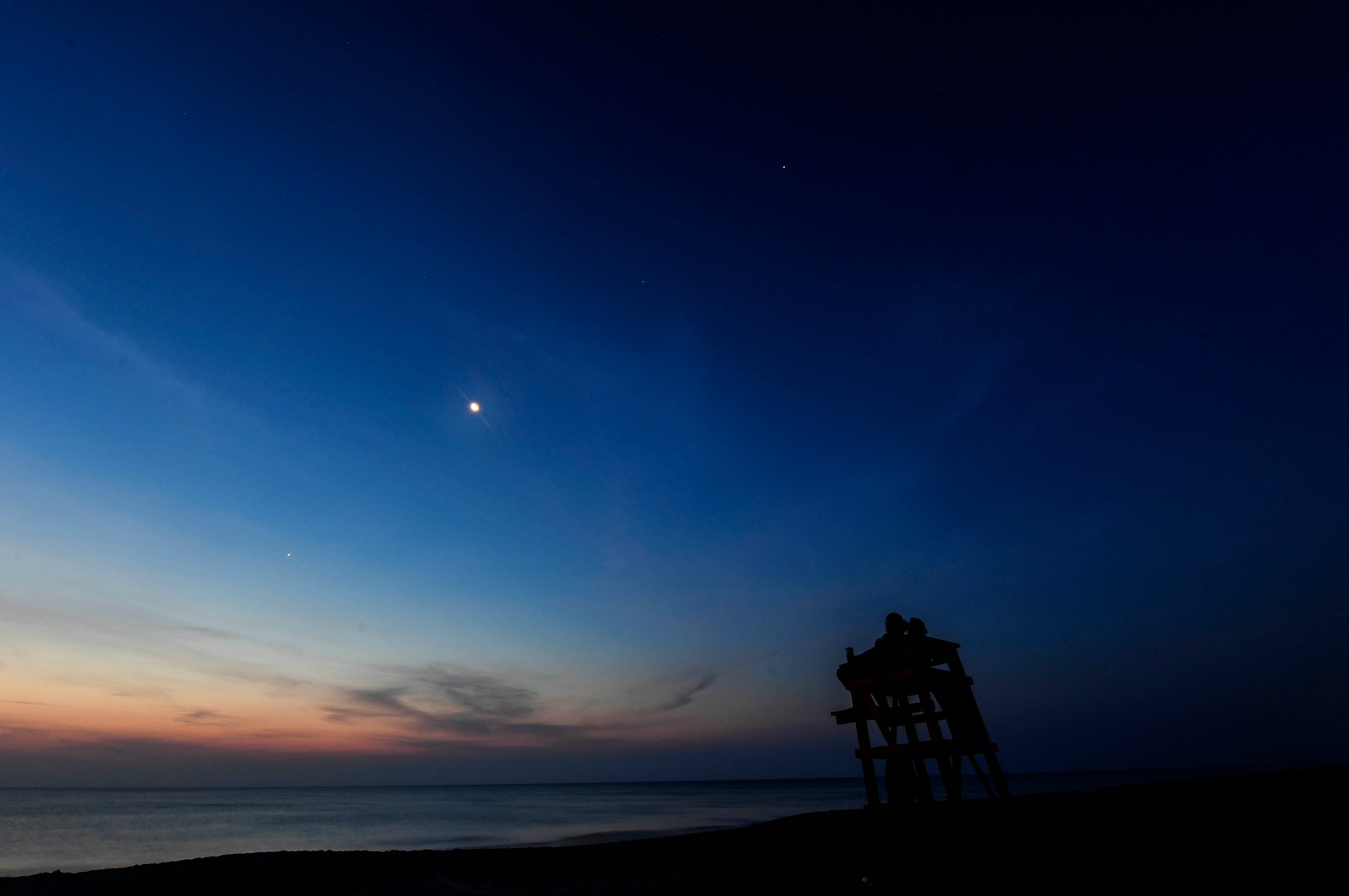 The crescent Moon joins the planets Mercury, Venus, Uranus, Mars, Jupiter and Saturn in alignment over Melbourne Beach Friday morning, June 24, 2022. Craig Bailey/FLORIDA TODAY via USA TODAY NETWORK