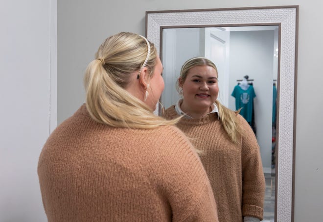 Layne Moorman, owner of Naomi Clay Creations, looks at herself in a mirror inside the Cranberry store where she sells some of her handmade jewelry on December 21, 2019. February 21, 2022 in Chillicothe, Ohio.