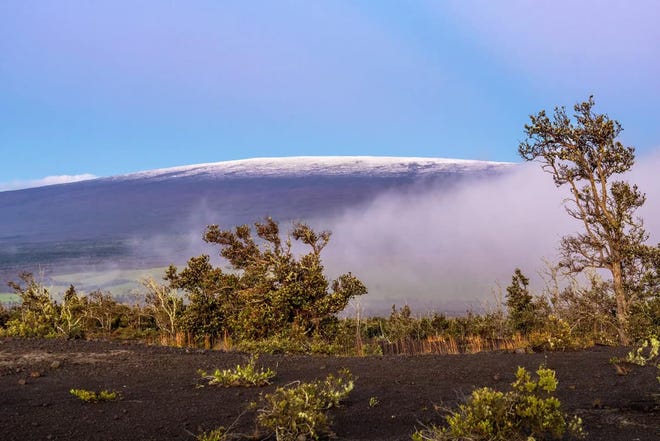 Snow tops Mauna Loa on Tuesday, shortly after the volcano stopped erupting.