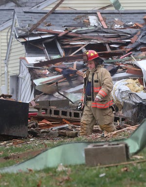 A Coventry Township Firefighter Lieutenant on the scene of a home explosion on West Long Lake Boulevard on Dec. 22 in Coventry Township.