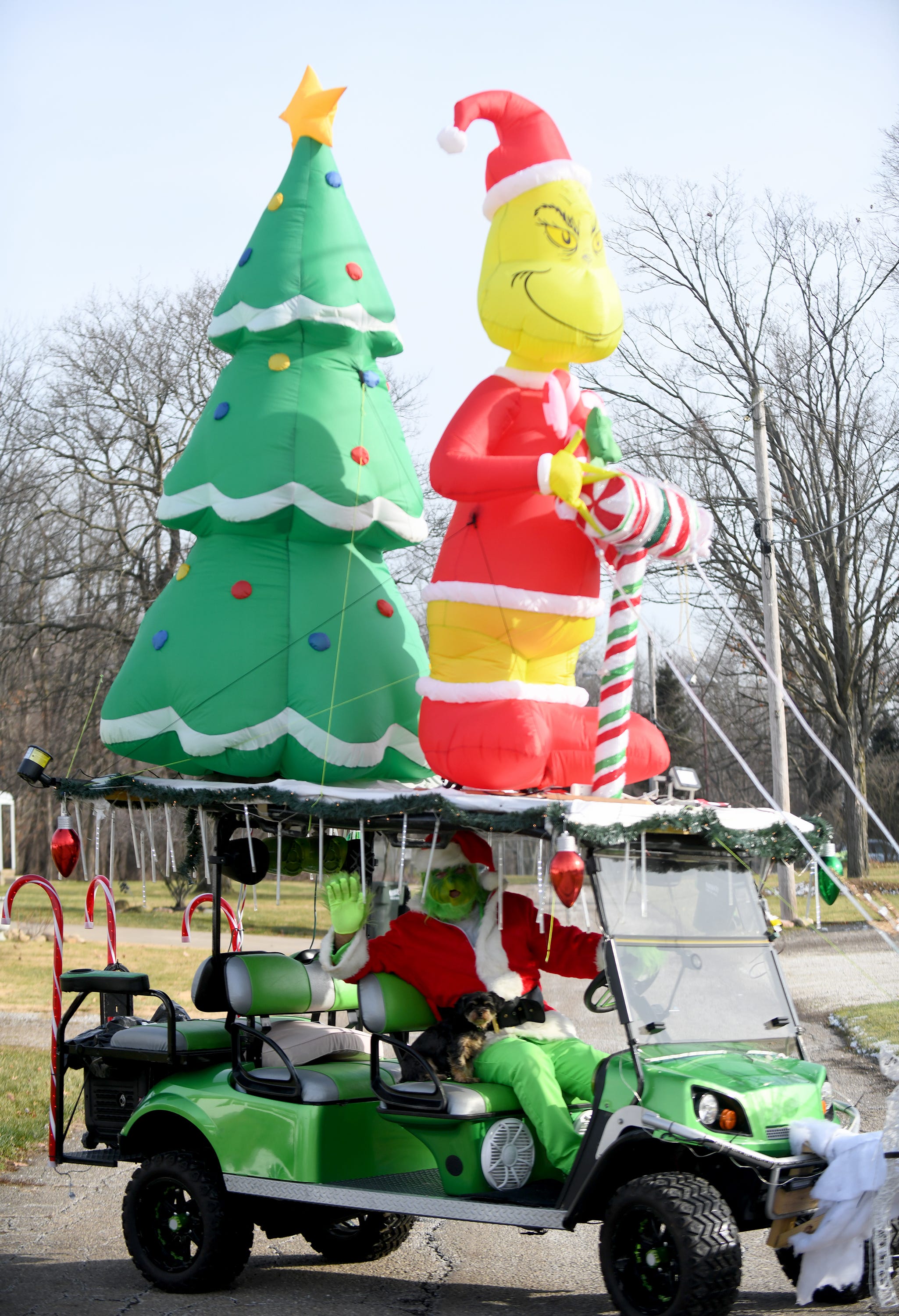 Vaughn Mohler dresses as the Grinch and drive around in golf cart