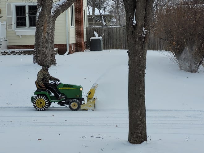 With plowing of snow routes the city's priority, a resident of Des Moines' West Drake neighborhood clears 36th Street on Thursday.