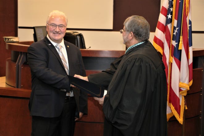 Marion County Commissioner-elect Mark Davis, left, shakes hands with Marion County Family Court Judge Robert Fragale after taking the oath of office on Wednesday, Dec. 21, 2022. Davis will officially take his seat on the board of county commissioners at the Jan. 5, 2023, meeting.