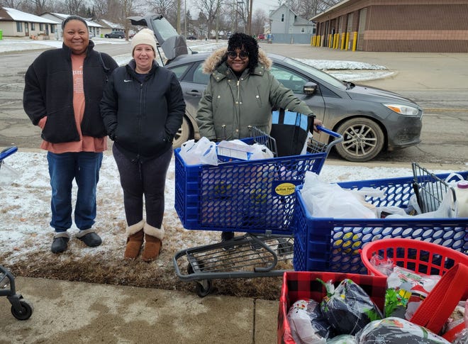 Patrice Johnson, Melissa Hoffman, and Tracy Spencer picked up items from Chuck Waggin', a mobile pet pantry that makes visits monthly to Active Faith in South Lyon.