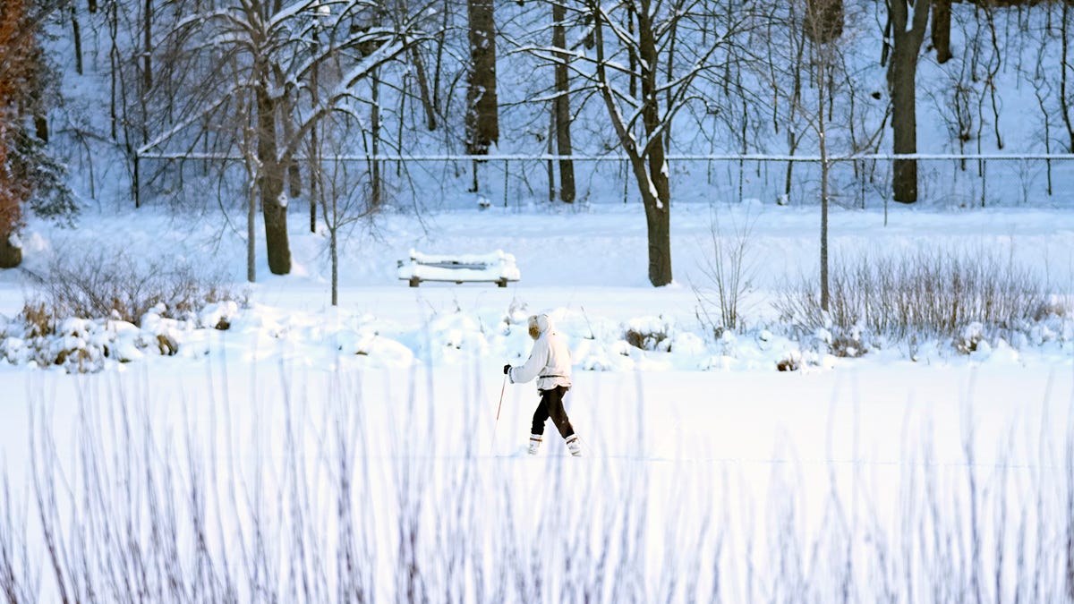 A skier makes her way across Lake of the Isles Thursday, Dec. 22, 2022, in Minneapolis. (AP Photo/Abbie Parr)
