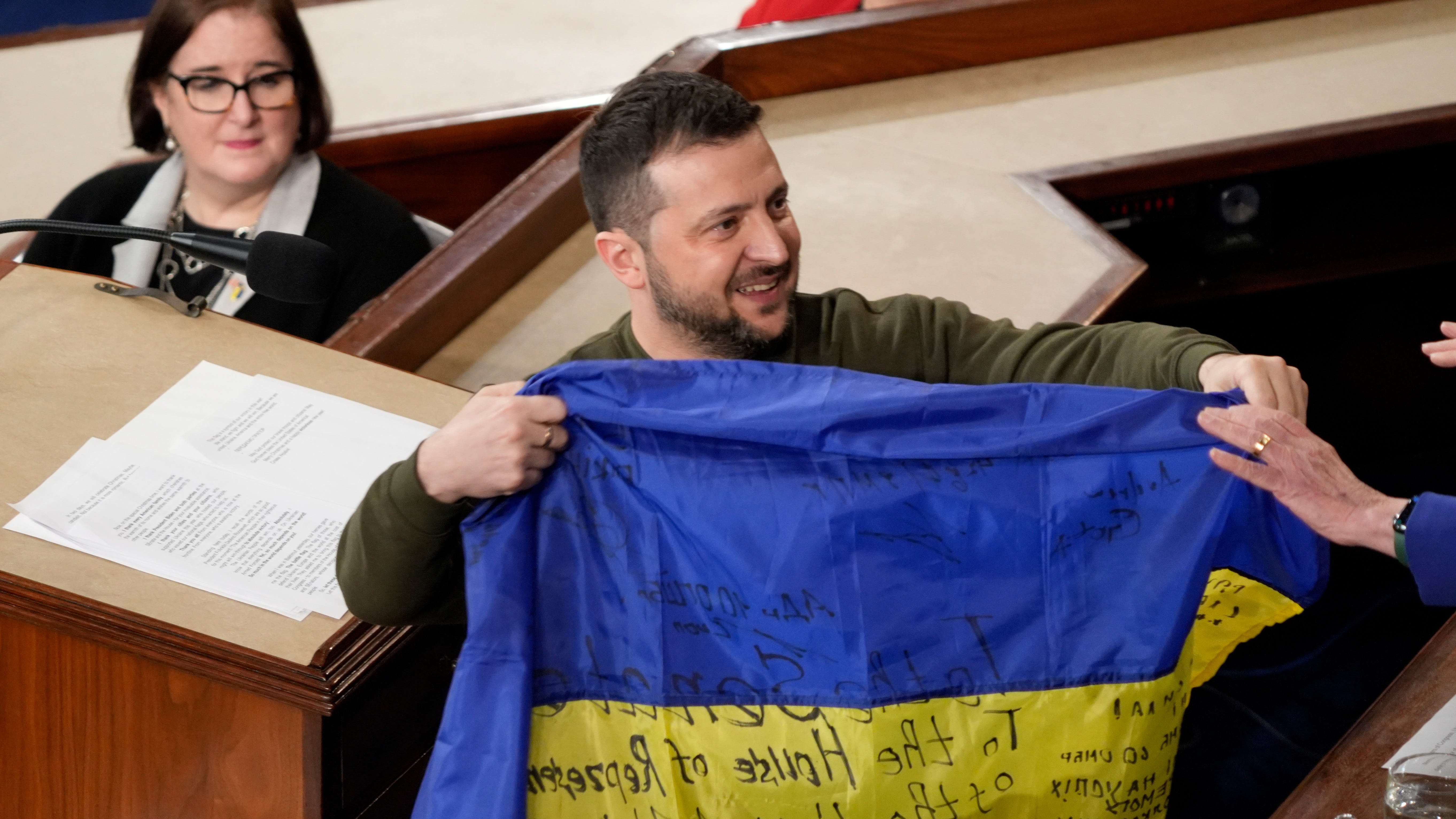 Dec 21, 2022; Washington, DC, USA; President Volodymyr Zelenskyy of Ukraine gives a flag to Speaker of the House Nancy Pelosi (right) after addressing a joint meeting of Congress at the Capitol. The Ukrainian President visited Washington to meet with Biden and US lawmakers during his first trip outside his country since Russia began its violent invasion of Ukraine in February. Mandatory Credit: Jasper Colt-USA TODAY
