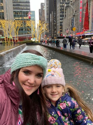 New Bern resident Tara Messier and her daughter, 6-year-old Aria, pose near Radio City Music Hall in New York before taking in a performance by The Rockettes.