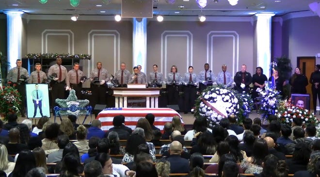 Detective Cindy Anavisca-Orrego, the cousin of Deputy Oscar Yovani Bolanos-Anavisca Jr., speaks Friday, Dec. 23, 2022, during his funeral service at Rivers of Living Water Church in Fayetteville. Bolanos-Anavisca Jr. was killed shortly after 2:45 a.m. Dec. 16, while investigating a robbery at the Circle K at 2990 Gillespie St.