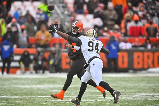 Cleveland Browns quarterback Deshaun Watson (4) is pressured by New Orleans Saints defensive end Cameron Jordan (94) during the first half of an NFL football game, Saturday, Dec. 24, 2022, in Cleveland. (AP Photo/David Richard)