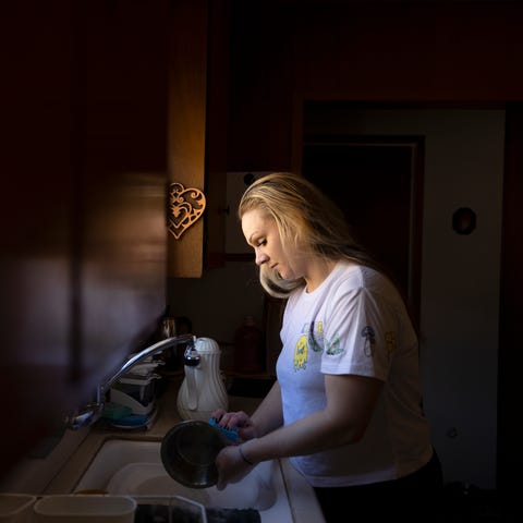 Sarah Fay, 28, washes dishes at her Grandmothers h