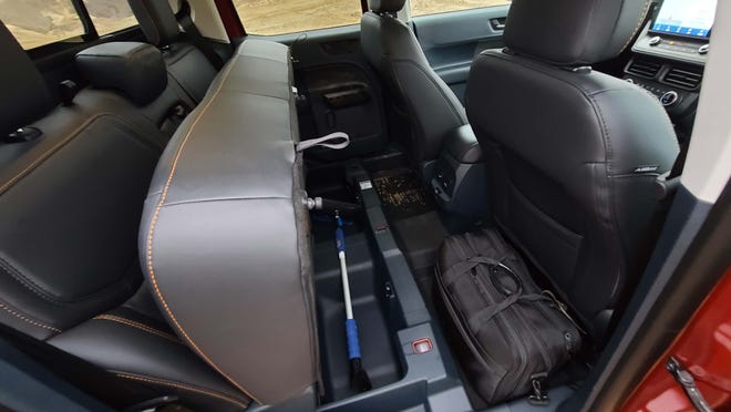 Like Big Brother F-150, the 2023 Ford Maverick Tremor has useful storage under the rear seats.