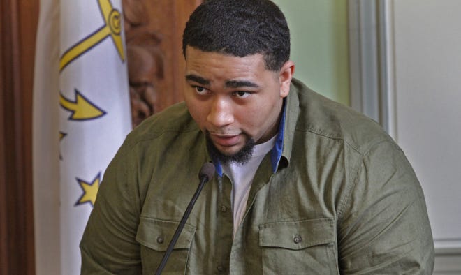 Donovann Hall testifies in Superior Court in July 2014. A Superior Court judge on Tuesday found that the state did not honor an agreement prosecutors made with Hall to serve a shorter time than three other triple-murder defendants because of his cooperation with prosecutors. 
 STEVE SZYDLOWSKI/THE PROVIDENCE JOURNAL