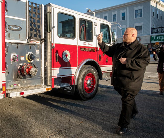 WORCESTER - The Rev. Jonathan J. Slavinskas, fire chaplain for the fire department, blesses new Engine 4 at the Park Avenue Fire Station Tuesday. A handful of city and fire officials were on hand for a brief ceremony, common after a new vehicle is added to a fleet. The E-One Typhoon pumper replaces a 2003 pumper that will be kept as a spare.