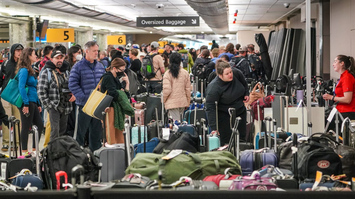 Bags at Denver International Airport sit awaiting reunification with their owners on Tuesday, Dec. 27, 2022.