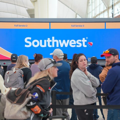 People wait in line for customer assistance from S