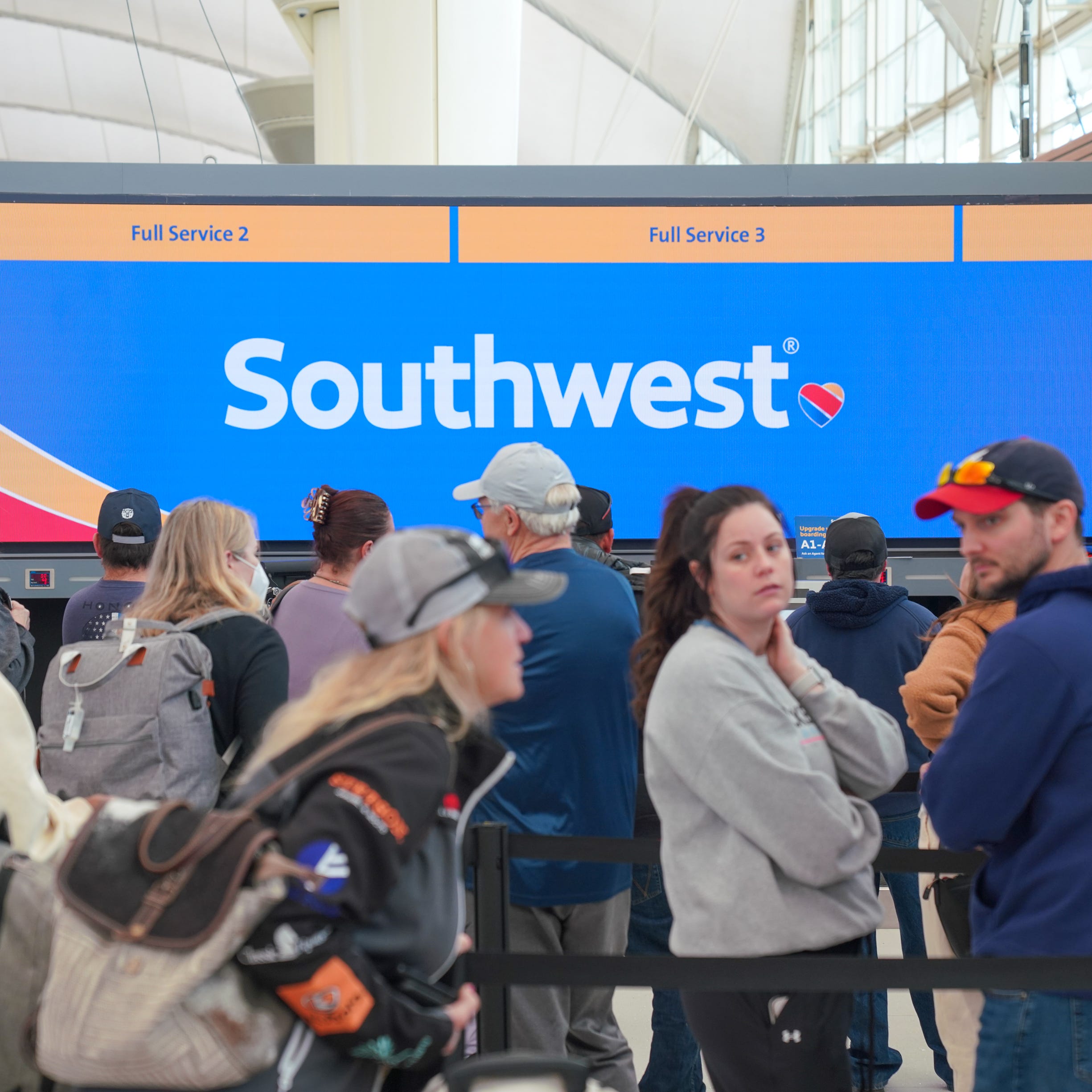 People wait in line for customer assistance from Southwest at Denver International Airport on Tuesday, Dec. 27, 2022.