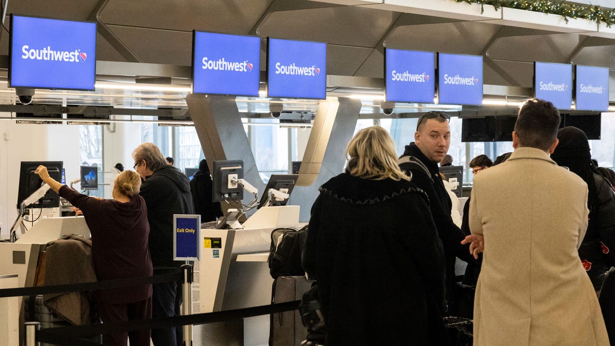 Passengers wait in line to check in for Southwest Airlines flights at LaGuardia Airport on Dec. 27.