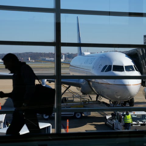 A United Airlines plane sits at a gate at Ronald R