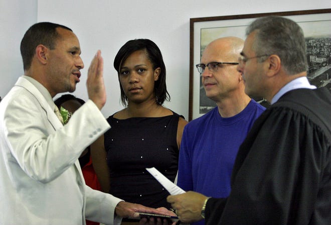 Councilman Ed Johnson is joined by his niece Danielle Johnson-Webb and partner Jeff Lundenberger at his swearing-in by Municipal Court Judge Mark Apostolou at the Asbury Park City Council organization meeting on July 1, 2005.