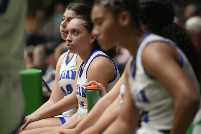 Mishawaka Marian Knight guard Nevaeh Foster (14) listens to the coach while resting on the bench on Thursday, Dec. 29, 2022, during the Indiana Hall of Fame Classic at New Castle Fieldhouse. Bedford North Lawrence defeated Mishawaka Marian, 59-28. 