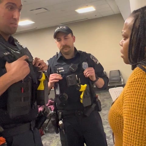 Shelley Morrison speaks to airport police officers
