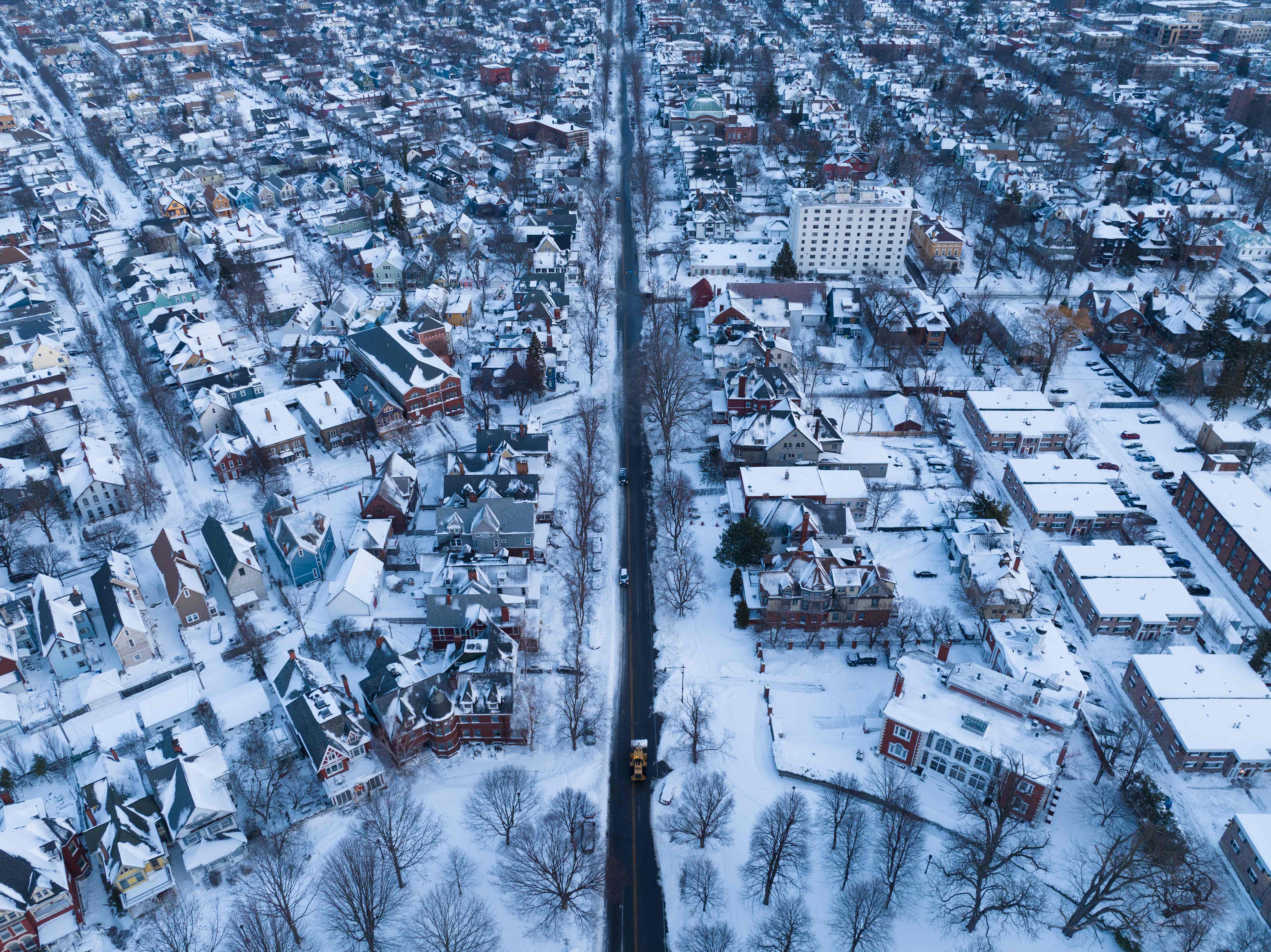 In this aerial photo, an excavator, center, makes its way up Richmond Avenue in Buffalo, New York, on December 28, 2022.