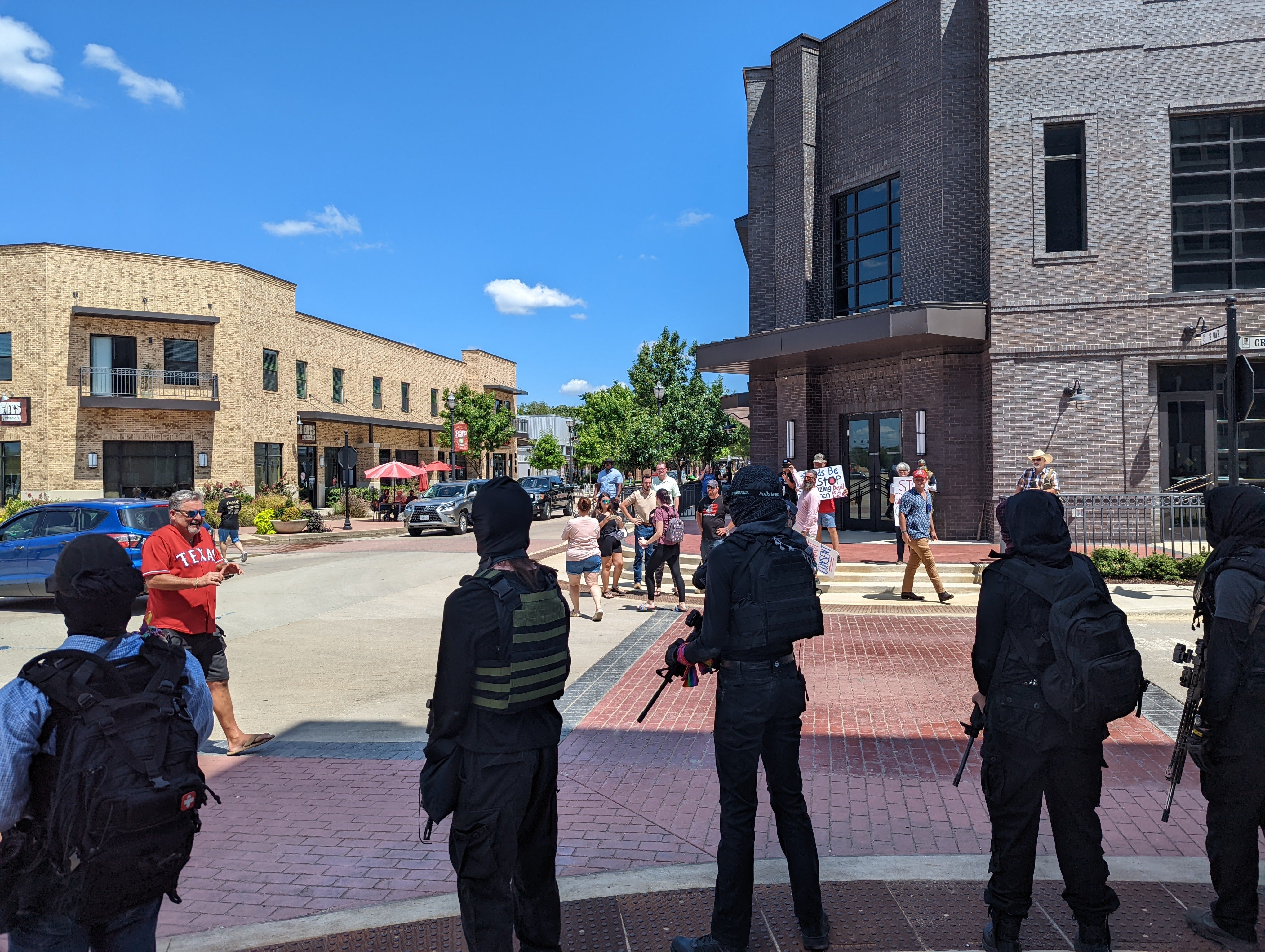 Members of the Elm Fork John Brown Gun Club arrived at the drag brunch carrying semiautomatic rifles. Some also wore pride flags. When protesters approached the show, the gun club directed them to stay back, according to videos from the day.