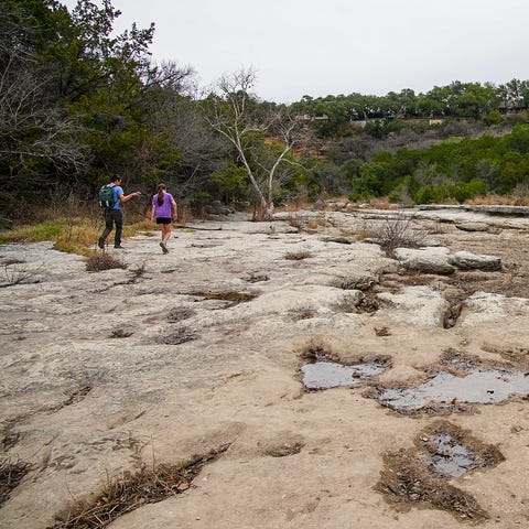 Hikers walk through a dry Campbell's Hole on the B