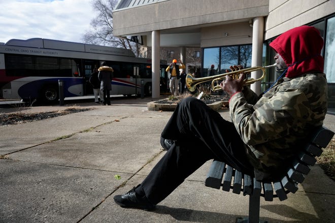 Dec. 29, 2022; Columbus, Ohio, USA; Roger Parish plays the trumpet outside the Latitude Five25 apartment complex, 525 Sawyer Blvd., on Columbus' Near East Side. Residents of Latitude 525 were being relocated into temporary housing due to a water main break. Mandatory Credit: Joseph Scheller/Columbus Dispatch