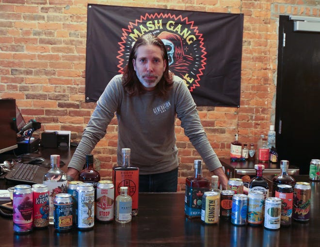 Rob Theodorow, owner of Generation NA, poses for a photo as he prepares his shop for