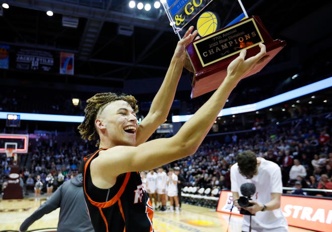 Republic's Ahlante Askew hoists the Blue Division championships trophy after beating the Sparta Trojans during the 77th annual Blue & Gold Tournament at Great Southern Bank Arena on Thursday., Dec. 29, 2022.
