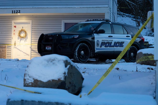 A Moscow police officer stands guard in his vehicle, Tuesday, Nov. 29, 2022, at the home where four University of Idaho students were found dead on Nov. 13, in Moscow, Idaho.