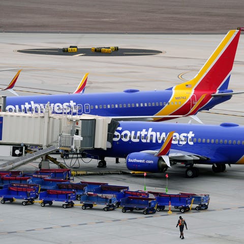 Southwest Airlines jets are parked at gates at Pho