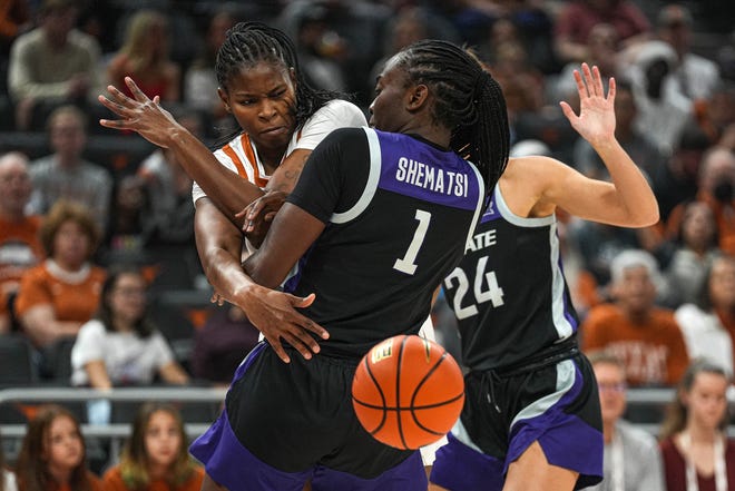 Texas forward Khadija Faye, left, passes the ball as she collides with Kansas State forward Sarah Shematsi during their game on Dec. 31 at Moody Center. Faye, who played her first two years at Texas Tech, is battling for the Longhorns' season rebounding lead.