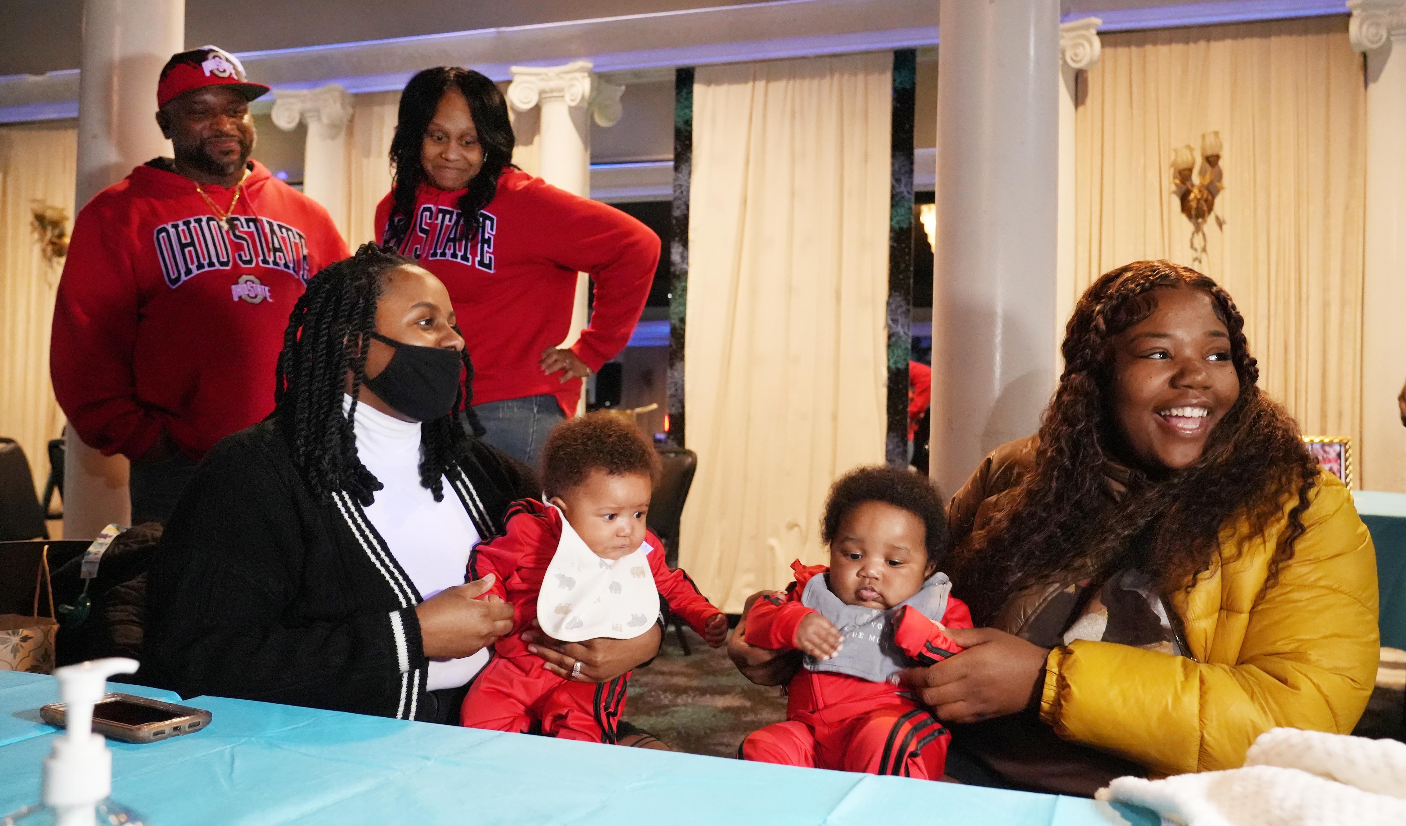 Wilhelmina Barnett, right, smiles as she talks with family, friends and media with her reunited twins, Kyair Thomas, left, and Kason Thomas. The 5-month-old boys had been the subject of an Amber Alert after a woman abducted them in Columbus, Ohio in December.