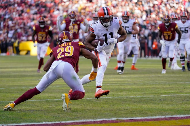 Cleveland Browns wide receiver Donovan Peoples-Jones (11) scores a touchdown past Washington Commanders cornerback Kendall Fuller (29) during the second half of an NFL football game, Sunday, Jan. 1, 2023, in Landover, Md. (AP Photo/Patrick Semansky)