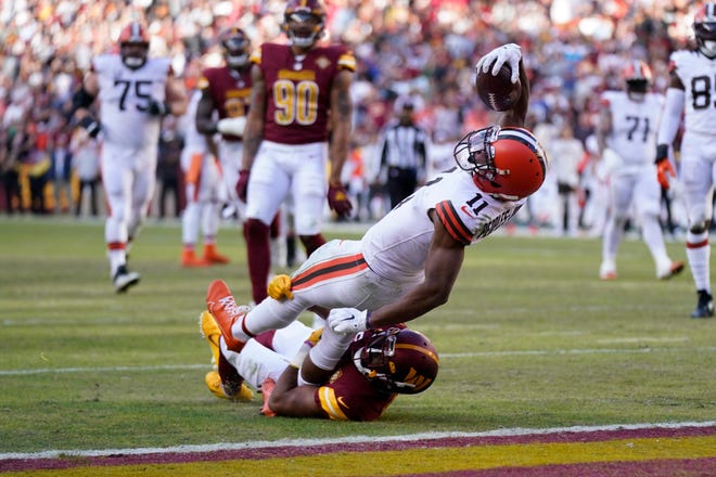 Cleveland Browns wide receiver Donovan Peoples-Jones (11) scores a touchdown past Washington Commanders cornerback Kendall Fuller (29) during the second half of an NFL football game, Sunday, Jan. 1, 2023, in Landover, Md. (AP Photo/Patrick Semansky)