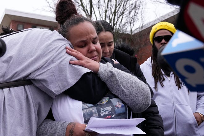 Megan Reed, center, receives a hug Sunday while speaking during a community event demanding justice for her son, 13-year-old Sin'Zae Reed, who was shot and killed on Oct. 12, 2022.
