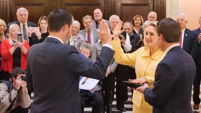 Ohio Secretary of State Frank LaRose administers the oath of office to Melanie Miller, who was elected to represent Ohio's 67th District. Miller's husband, Ashland Mayor Matt Miller, holds the Bible during a recent ceremony in Columbus.